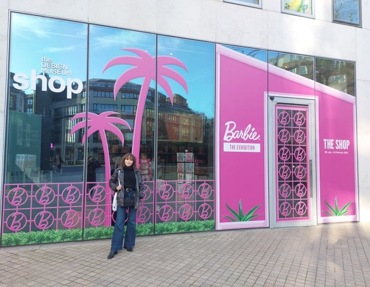 A woman stood outside a pink building