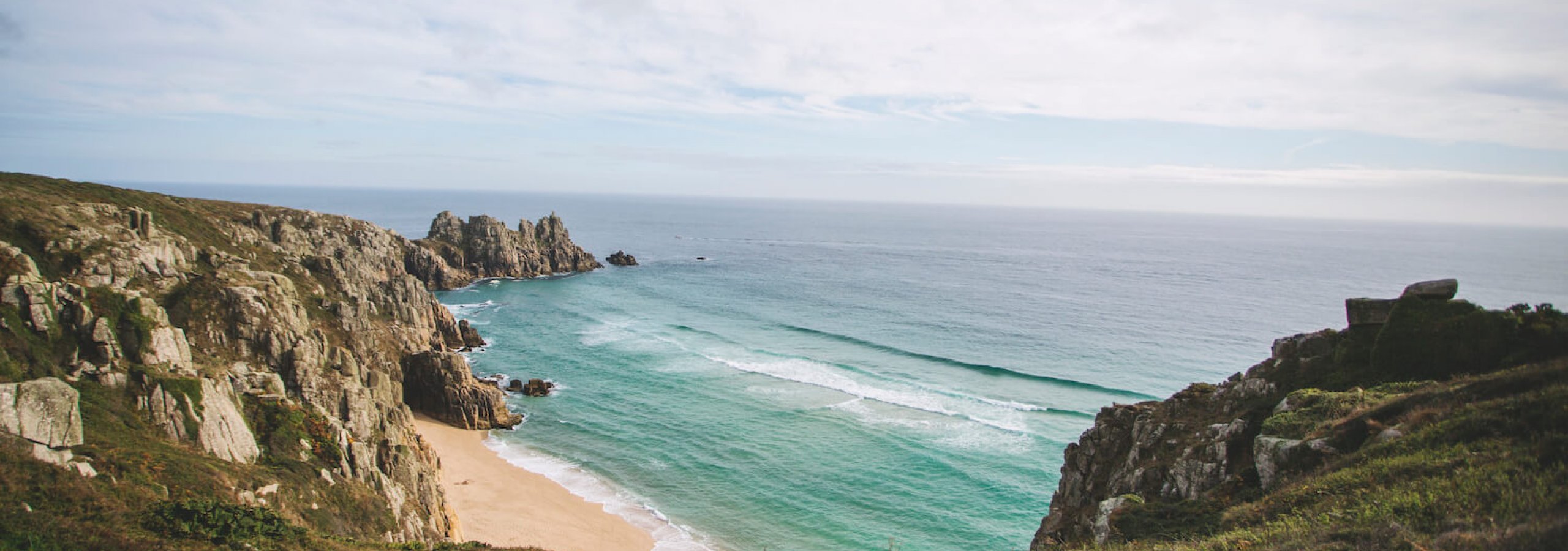 on a cliff top overlooking the beach and sea